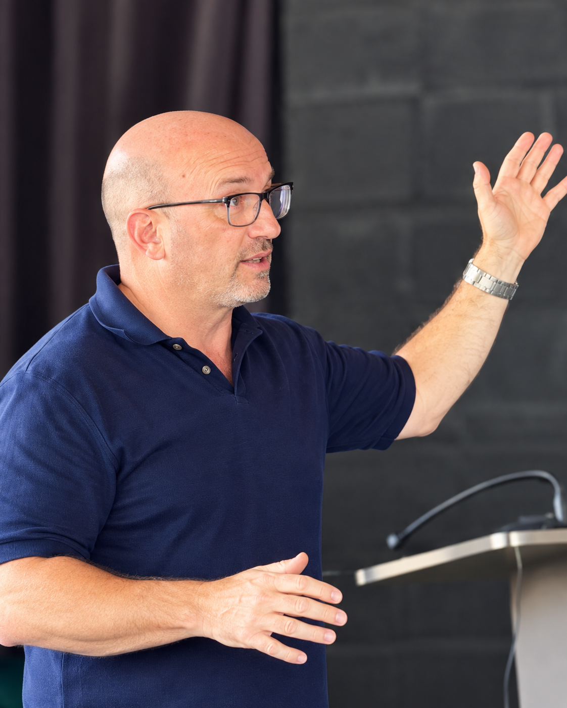 Sergio Mankita speaking and gesturing during a presentation